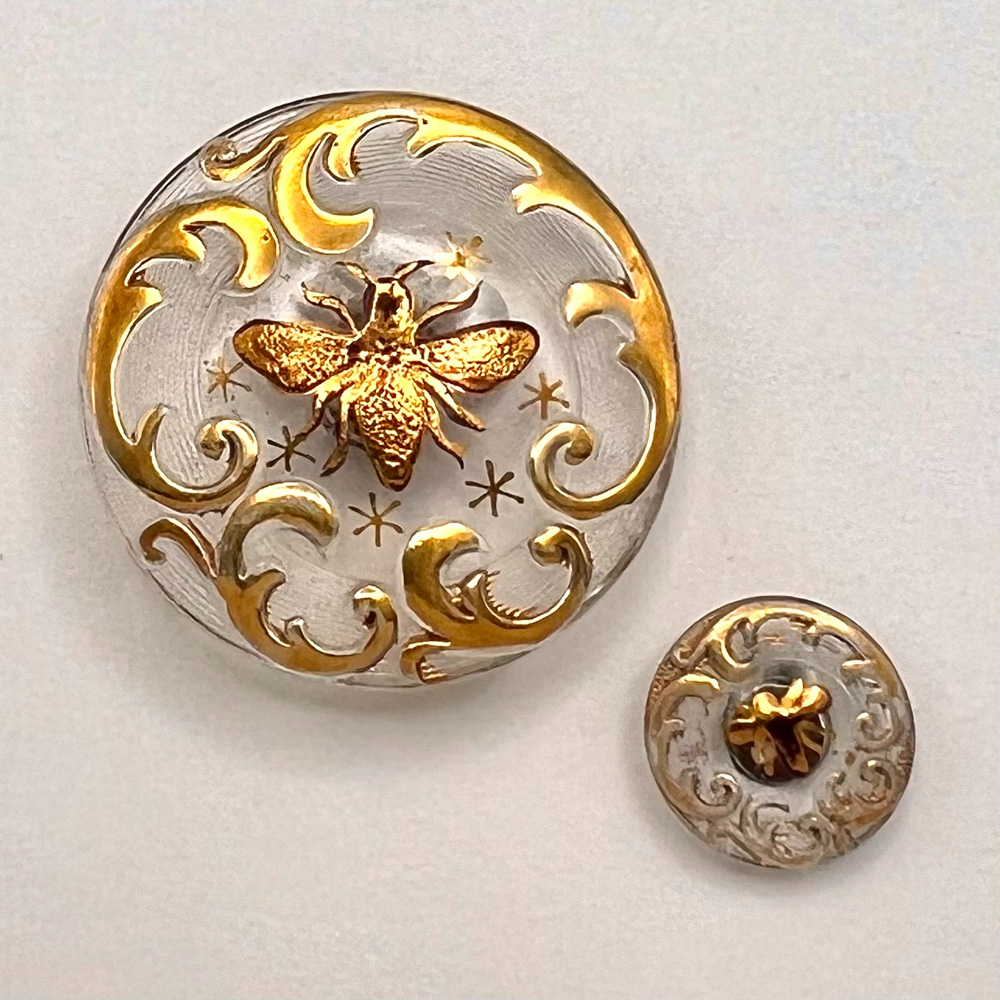 Clear Div. I glass buttons of a bee in mother/daughter sizes.