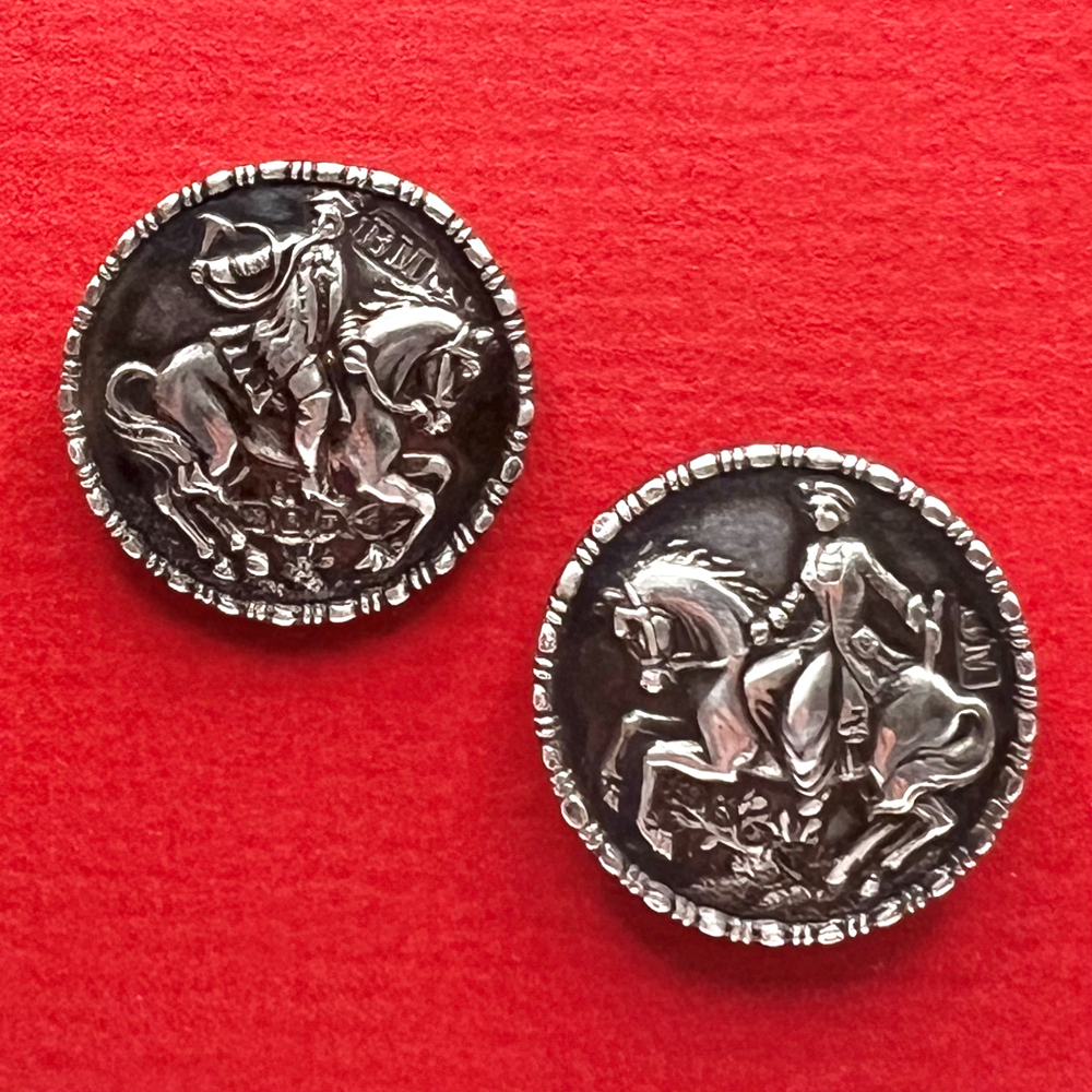 Pair of hallmarked silver buttons of a man and a woman on horseback.