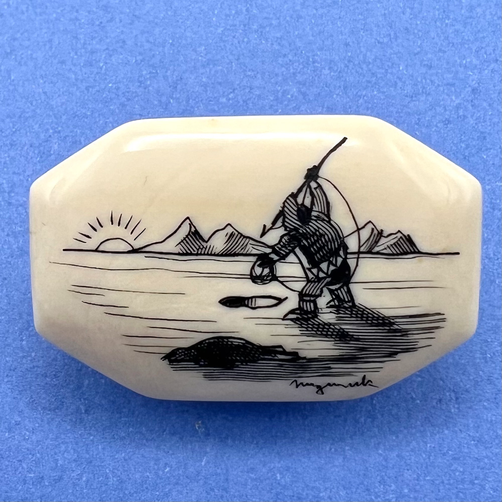 Eskimo ice fishing at sunrise with seal scrimshaw button.