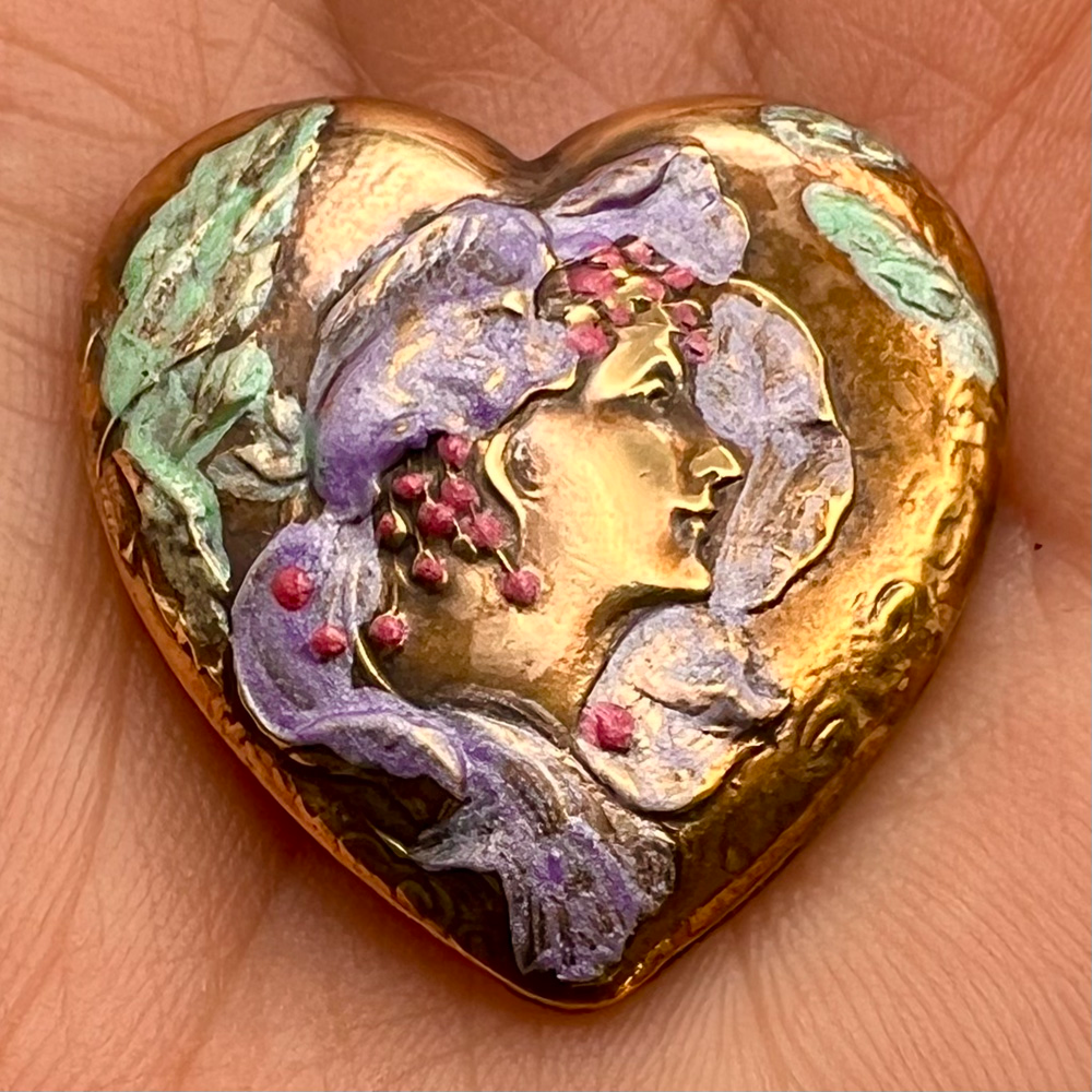 Heart shaped Art Nouveau enameled button of woman.