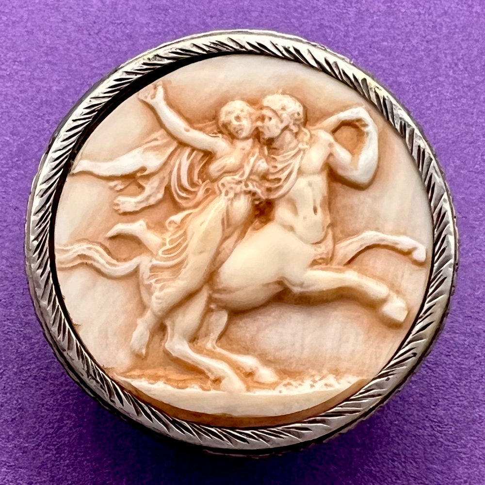 Ivoroid of Centaur carrying a  woman button.