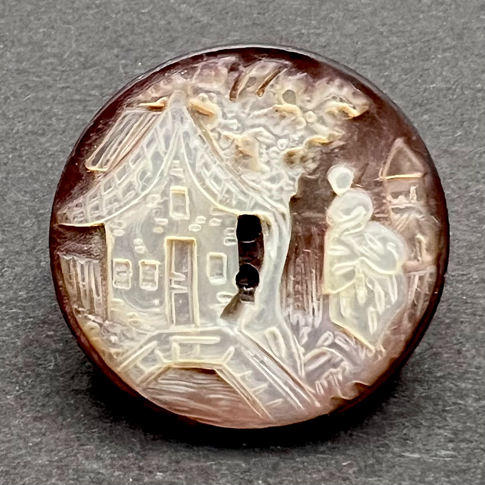 Cameo carved shell button of country scene.