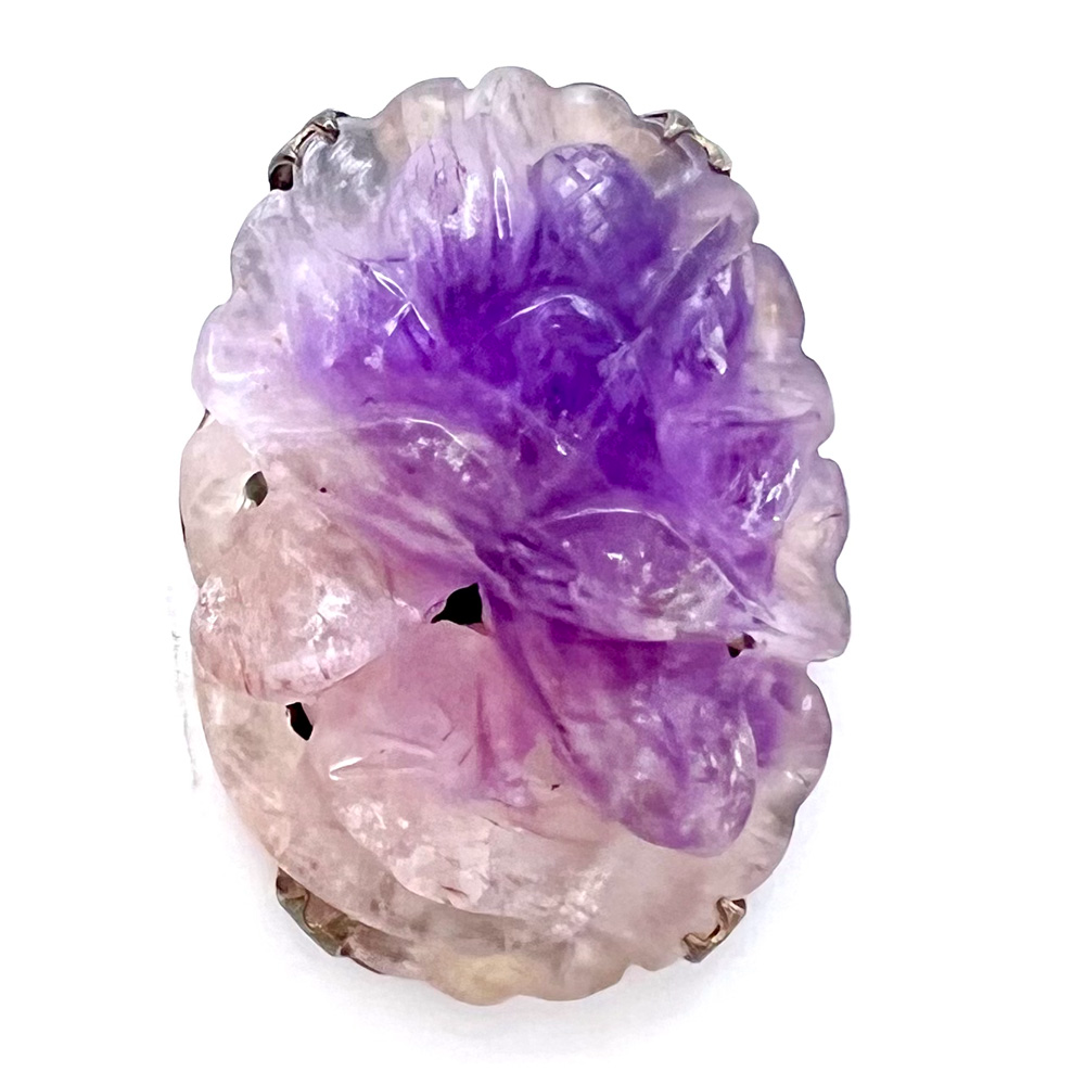 Carved purple jade button of a flower. 