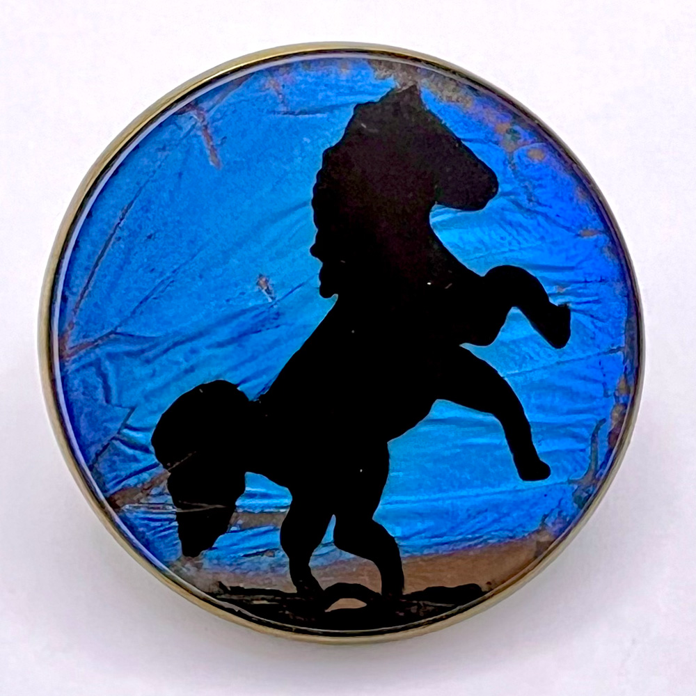 Reverse-painted studio button by Phil Linley of a rearing horse.