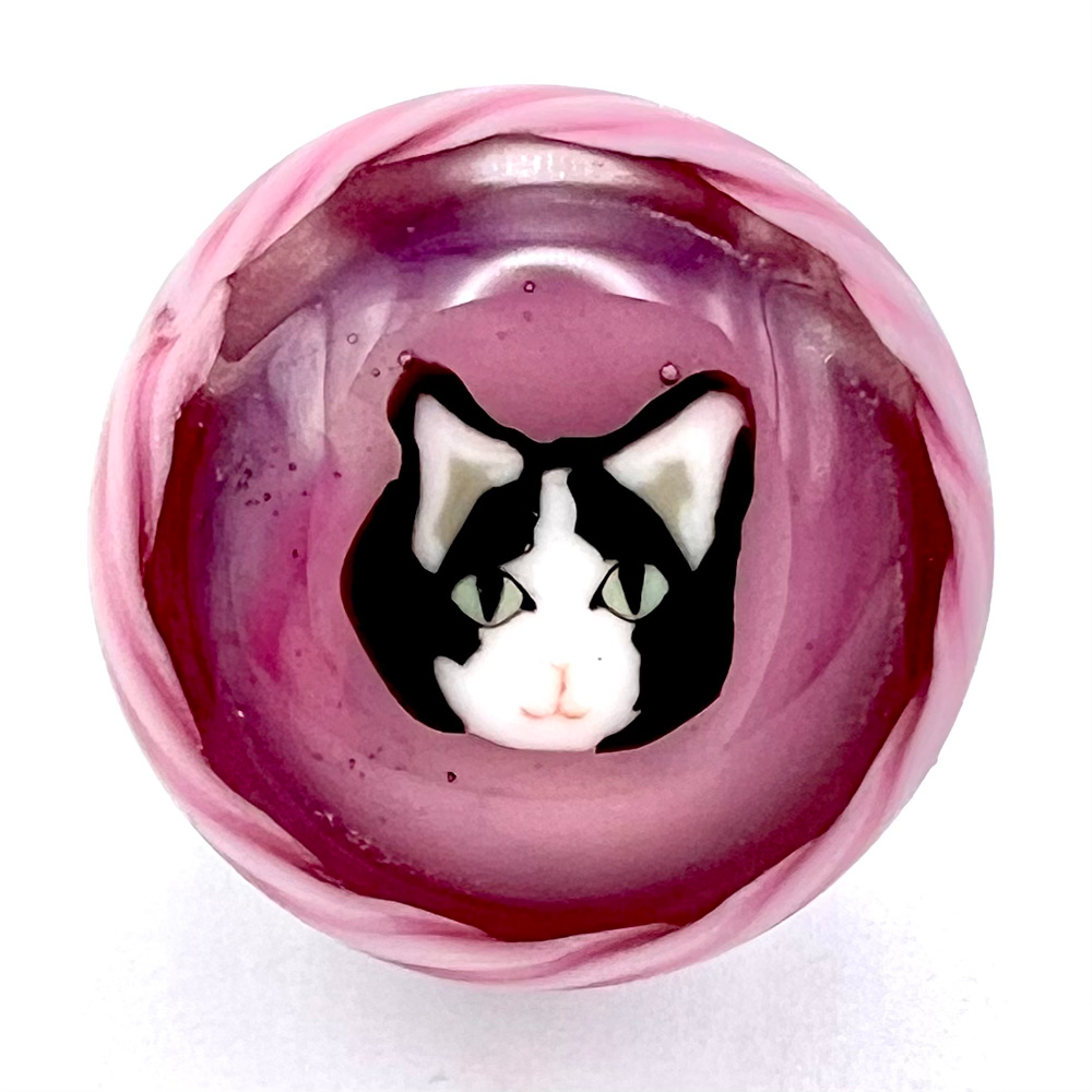Studio glass button of a cat face by Mavis Smith.