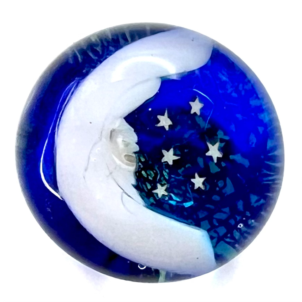 Mary Gaumond’s crescent “man in the moon” with stars studio glass paperweight button.