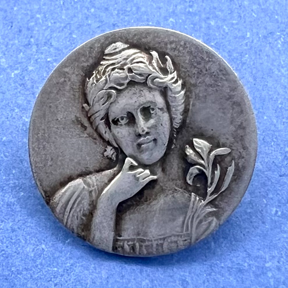 Highly Collectible 3rd Avenue Silver button of “Iris.”