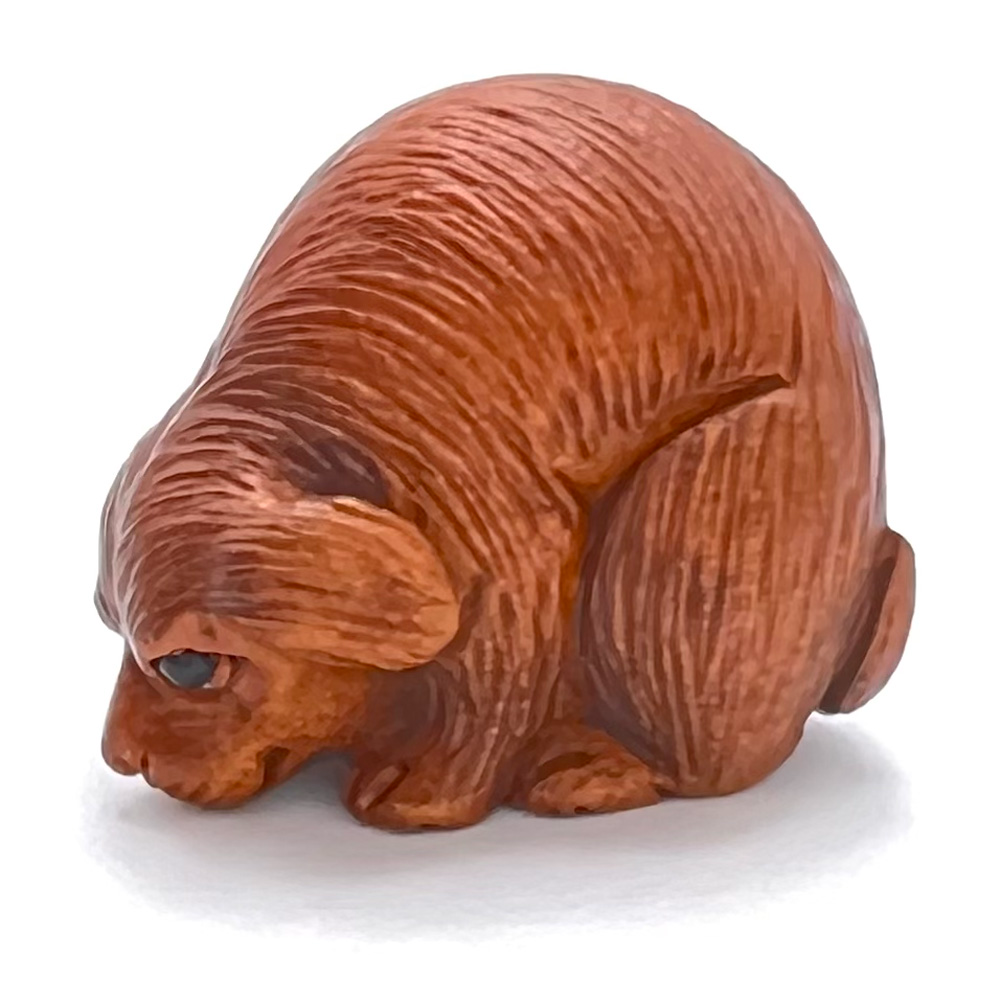 Boxwood realistic dog sniffing the ground button.