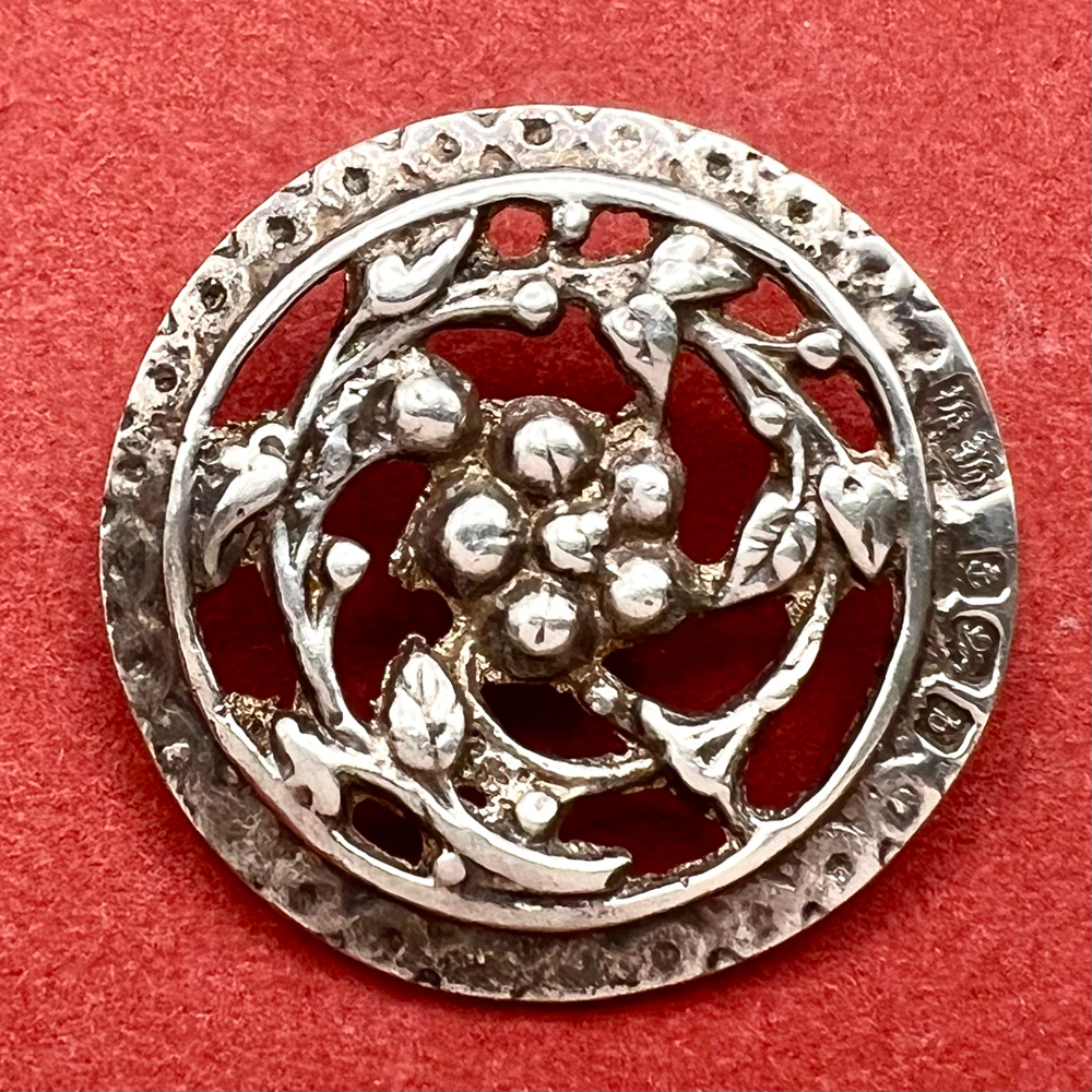 Hallmarked silver button of plant with berries. 