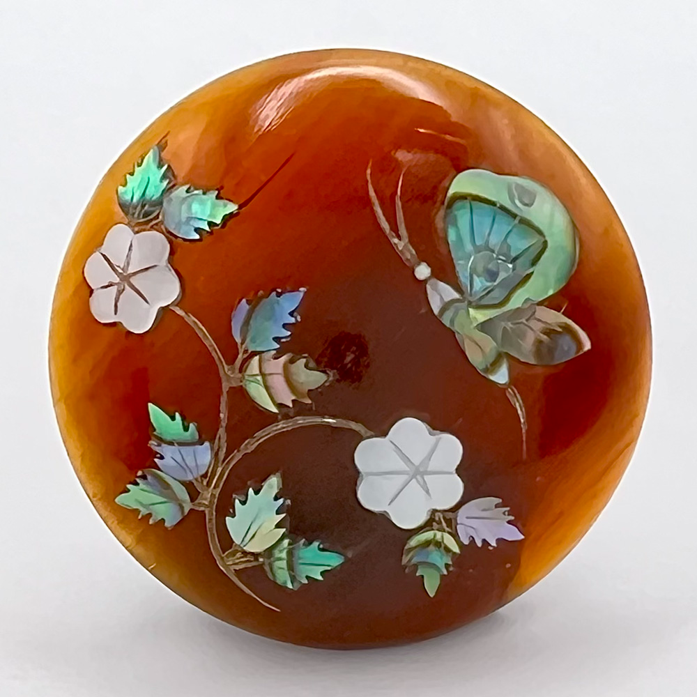 Inlay button of butterfly and flowers.