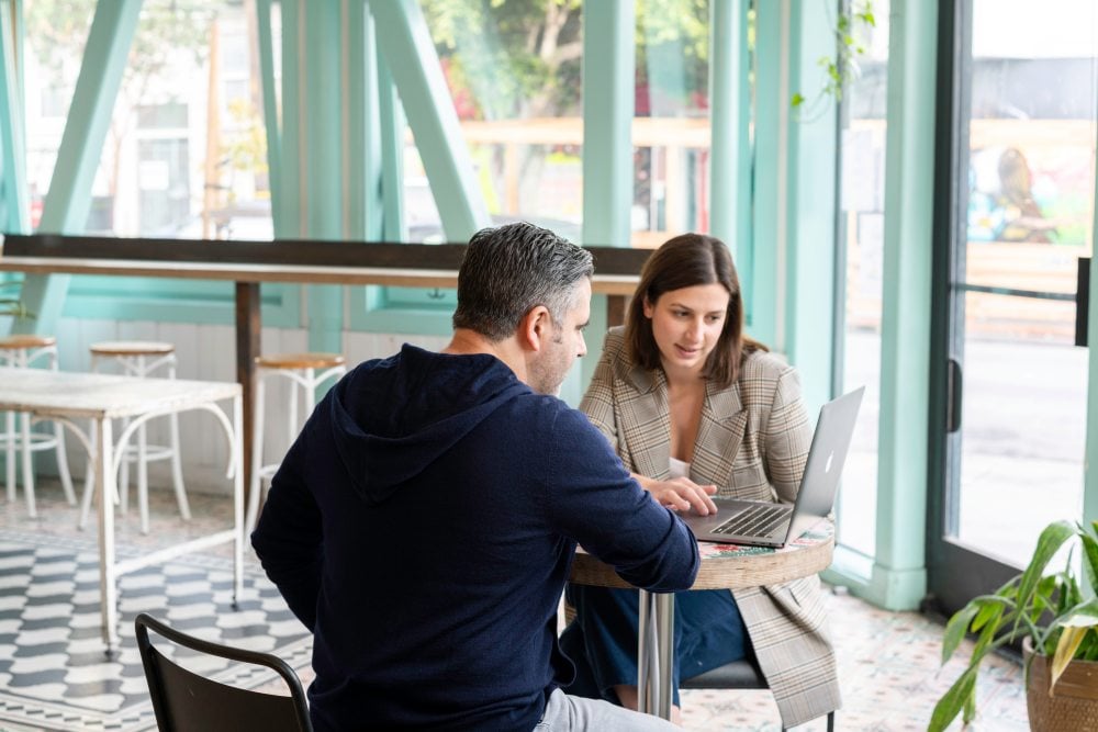 Man and woman working on laptop