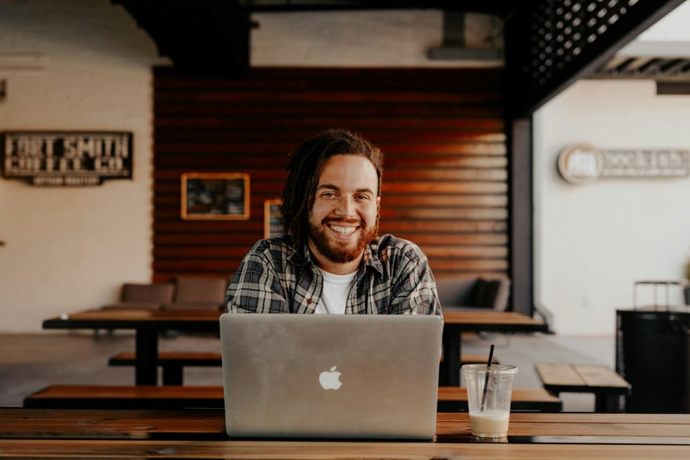 Man smiling over laptop