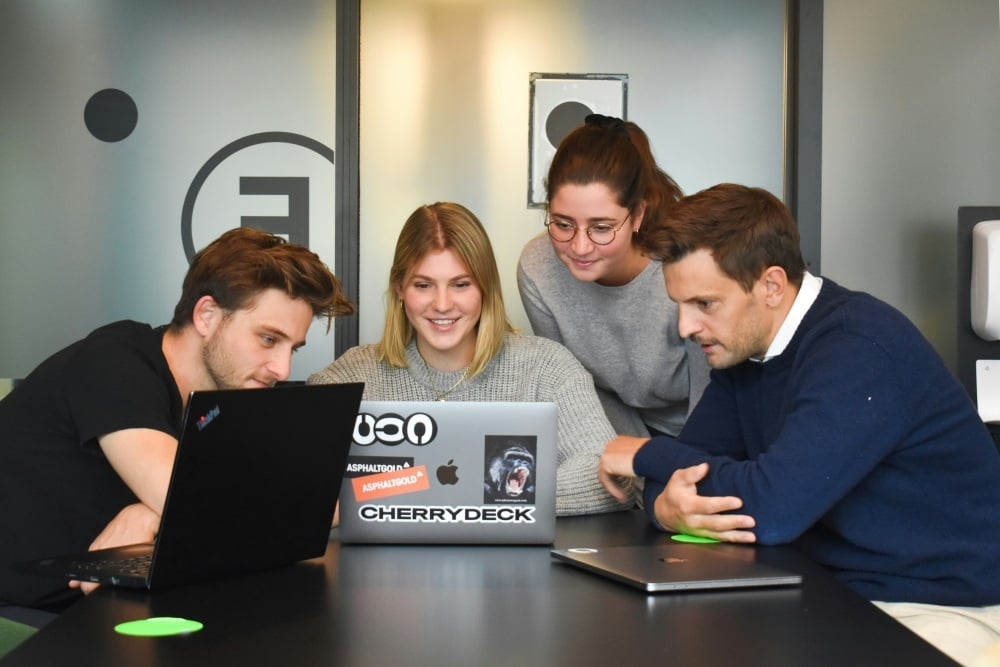 NPO team analyzing auction insights on laptop