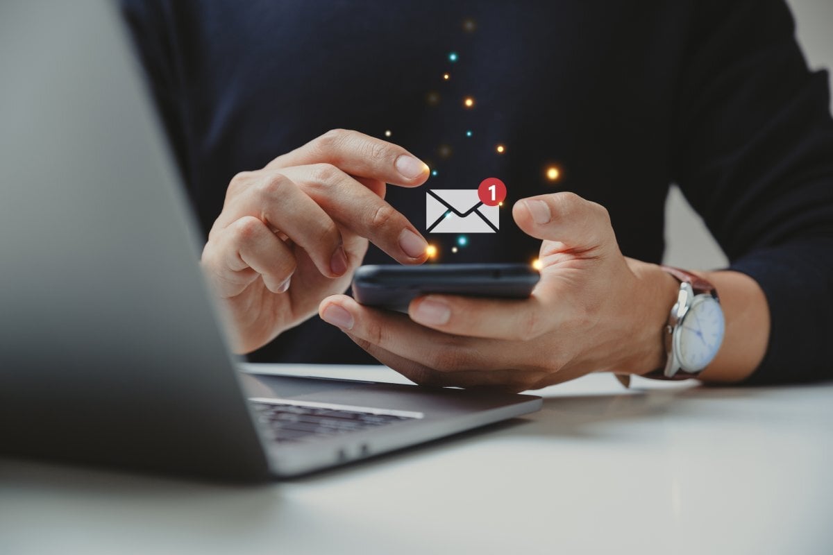 Person receiving an email on their mobile phone