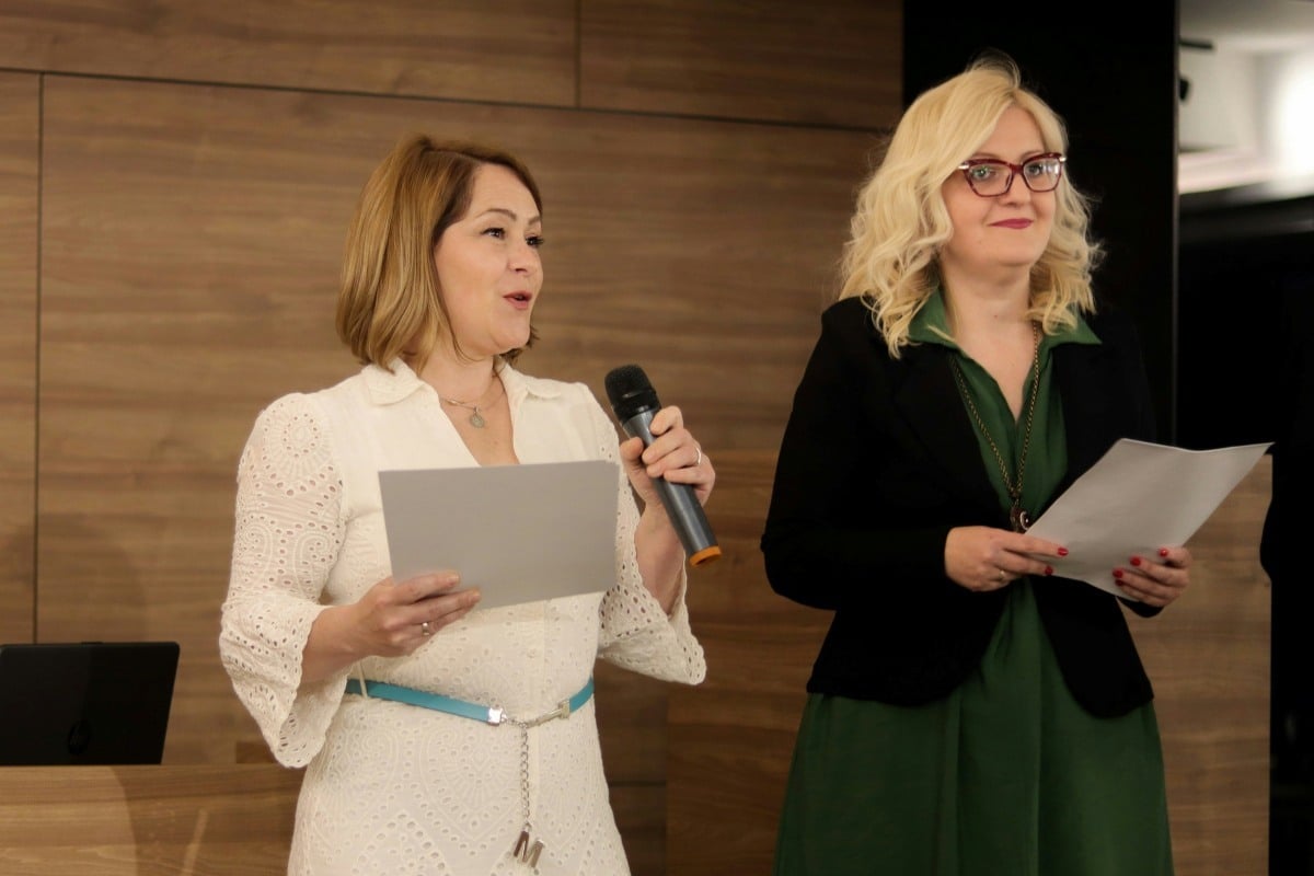 Two women hosting a silent auction