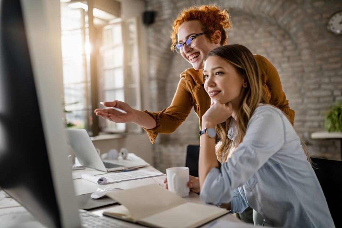 Two women working together at a computer