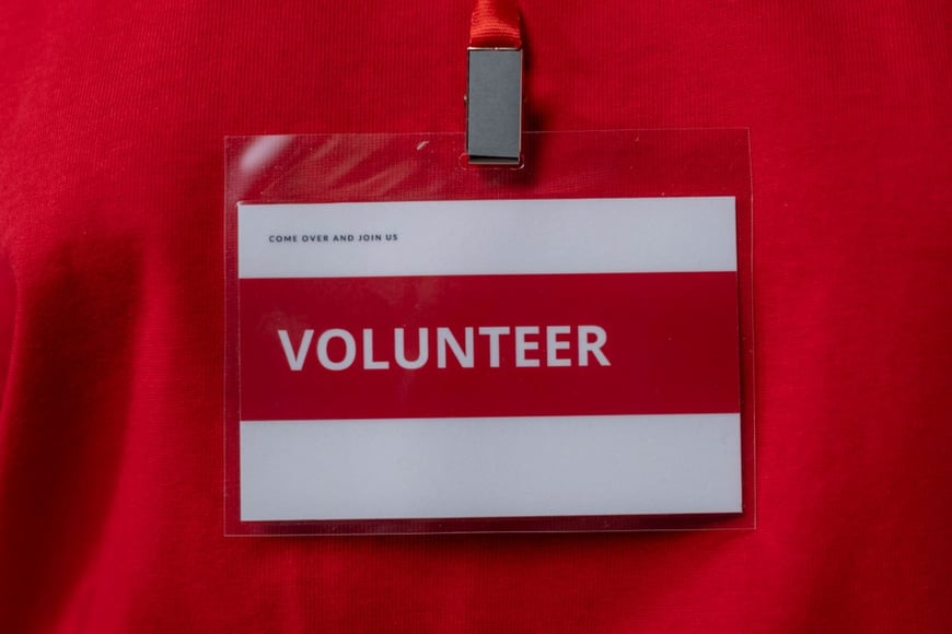 Volunteer badge on red fabric