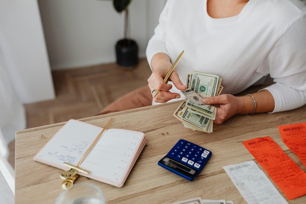 Woman counting money and budgeting