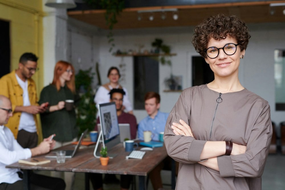 Woman smiling in front of her team