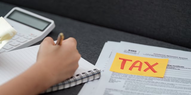 small-vecteezy_tax-preparation-individual-writing-notes-while-organizing_73042235_small