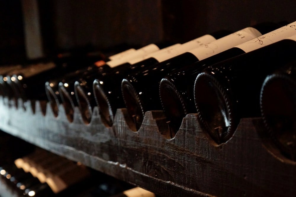 wine bottles lined up on a rack