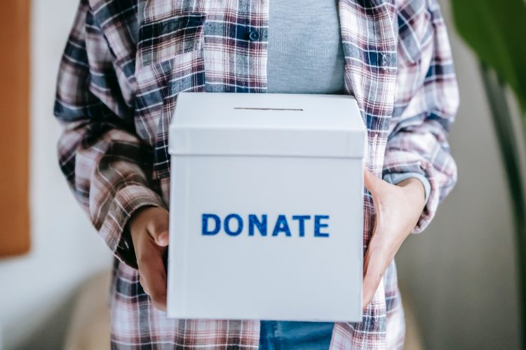 Person holding donation box