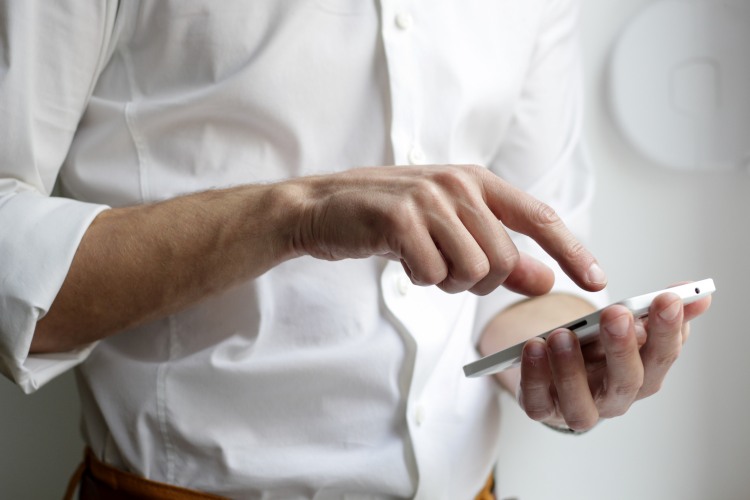 Person in white shirt on mobile phone