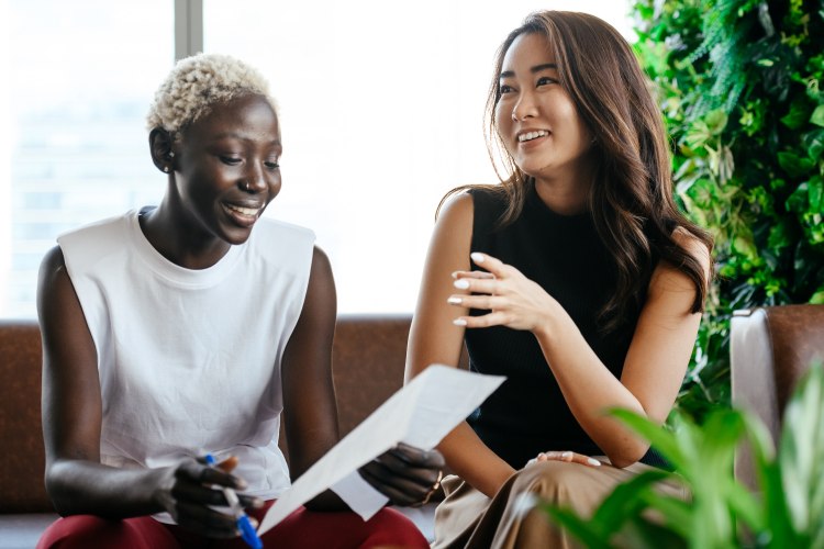 Two women sitting and laughing