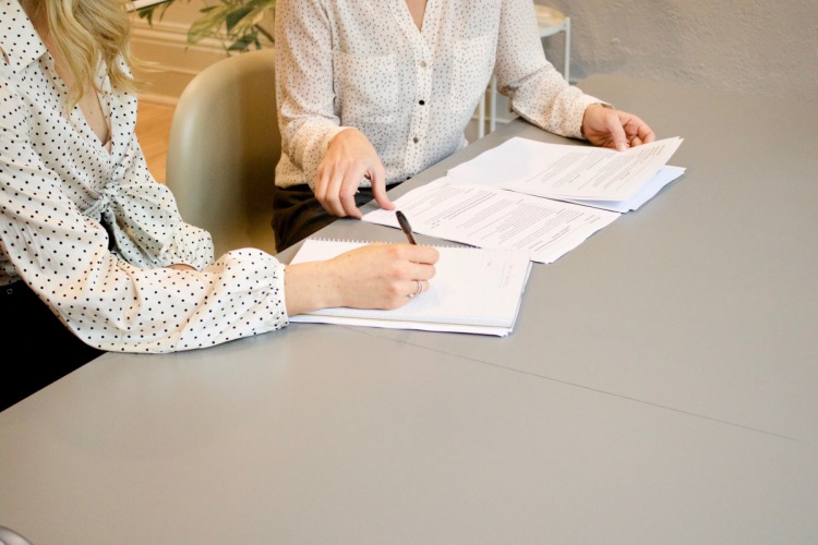 Two women working on documents