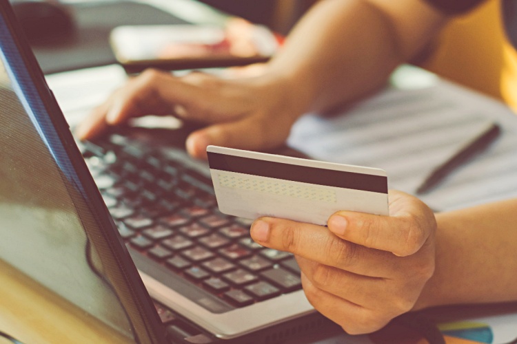 online-auction-person-on-laptop-with-credit-card